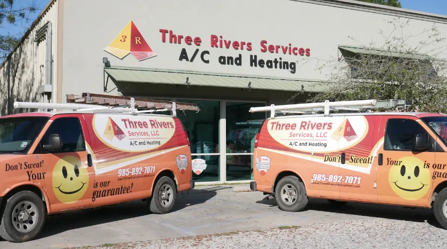 three river vans in front of company building